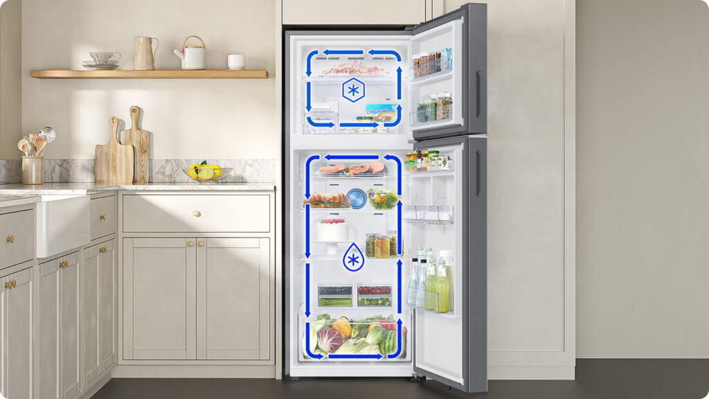 The Samsung 396L Refrigerator with Twin Cooling Technology combines style, performance, and advanced features to enhance your kitchen. With Twin Cooling Plus™ technology, it maintains separate cooling systems for the fridge and freezer, ensuring optimal freshness without odor mixing. The 5-in-1 Convertible feature offers flexible storage, allowing you to switch between five modes to suit your needs. It’s energy-efficient with AI Energy Mode, saving up to 10% on energy bills, and can be controlled remotely via the SmartThings app. Its sleek design features recessed handles and a premium Real Stainless finish, while additional features like Power Cool, Power Freeze, and SmartThings lighting enhance convenience. Ideal for modern homes, it’s equipped with a digital inverter compressor, offering reliable, long-lasting performance with a 20-year warranty. Samsung Refrigerator Price in Nepal [Updated 2025]